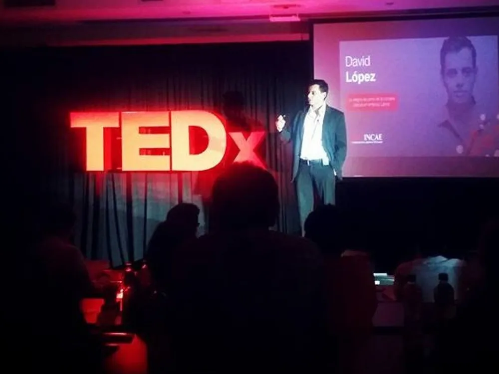 David Lopez speaking on a TEDx stage